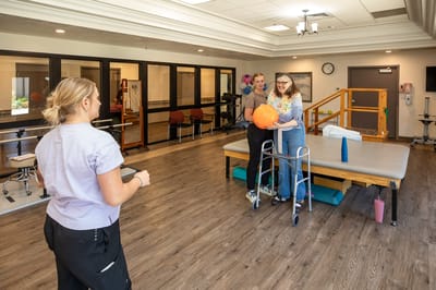 Residents participating in a therapeutic activity in a bright room