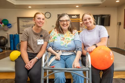 Staff members with a resident in an activity room