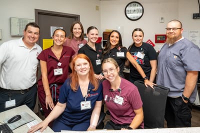 Staff members smiling together at the reception area