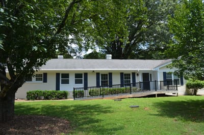 Exterior view of the facility with green lawn