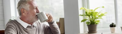 Senior man enjoying a cup of tea indoors