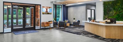 Bright and modern lobby area with seating and a reception desk