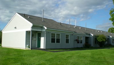 Exterior view of a residential building in a green setting