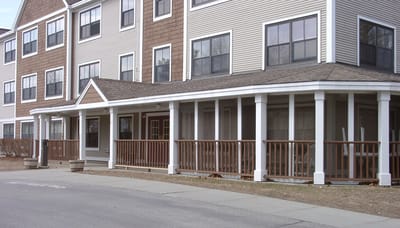 Exterior view of a senior living facility with porch