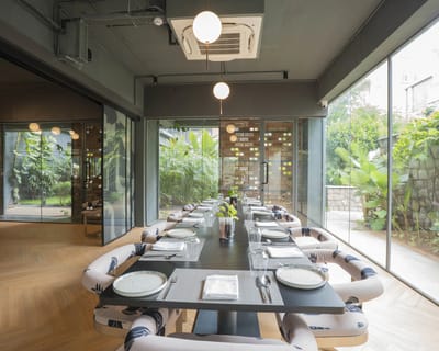Bright dining area with greenery visible outside