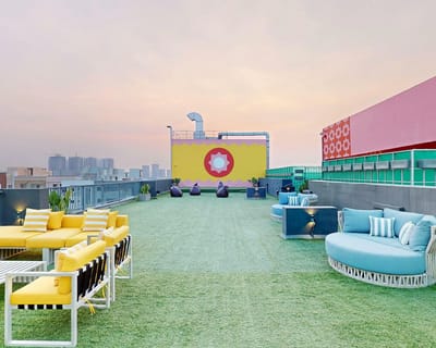Rooftop terrace with colorful seating and skyline view
