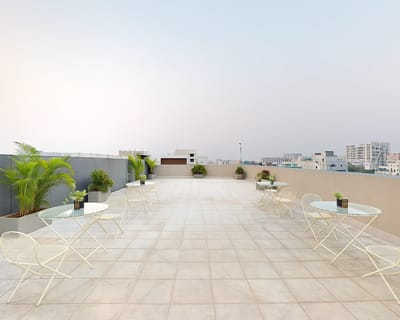 Spacious rooftop terrace with tables and plants
