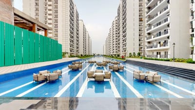 Outdoor pool area with lounge seating in a residential complex