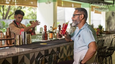 Residents enjoying cocktails at a lively bar area