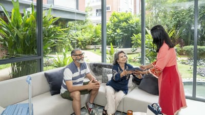 Residents engaging with staff in a lively common area
