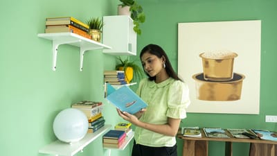 Young woman reading a book in a cozy interior