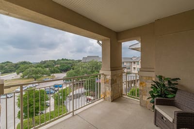 Outdoor balcony view of the facility with greenery