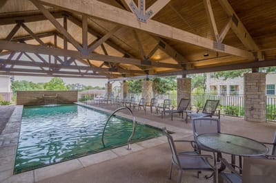 Indoor pool area with seating and covered patio