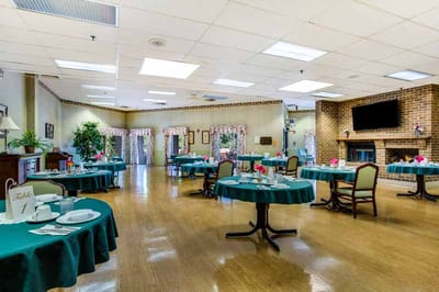Dining room setup with tables and chairs for residents