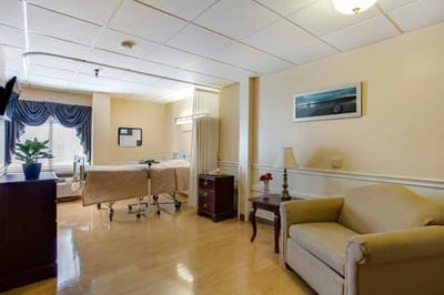 Bright resident room with a bed and seating area