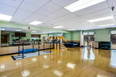 Spacious activity room with gym equipment and open floor