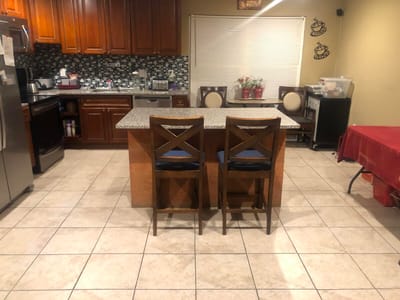Interior kitchen area with granite countertops and bar stools