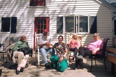 Residents and staff enjoying the outdoor patio area