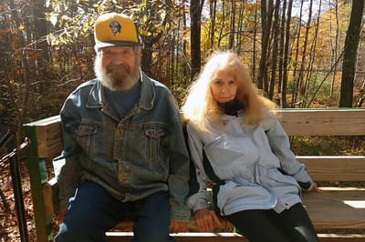 Two residents enjoying the outdoors on a bench
