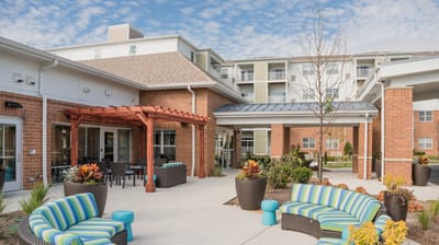 Outdoor seating area with vibrant furniture and landscaping