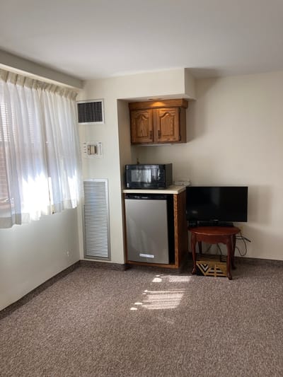 Cozy interior of a resident's room with kitchenette