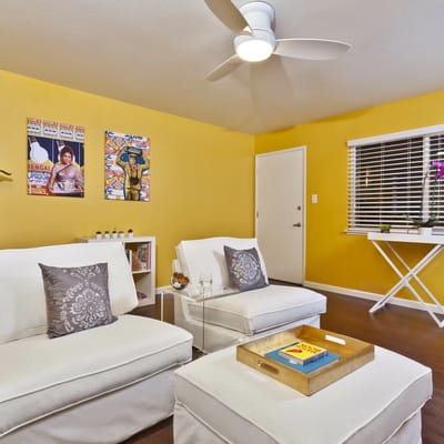 Cozy common area with white couches and vibrant decor