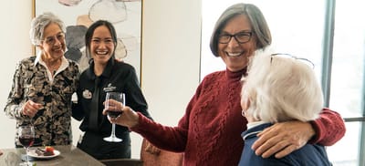 Residents and staff enjoying wine and conversation