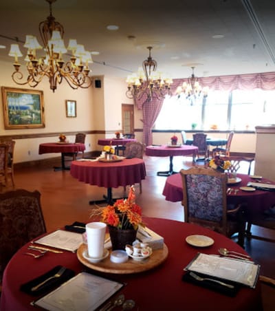 Bright dining room with tables set for a meal