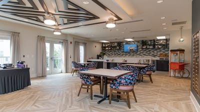 Common area with colorful seating and a coffee station