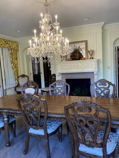 Elegant dining room with chandelier and ornate chairs