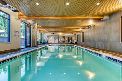 Indoor pool area with natural wood ceiling