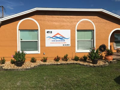 Building exterior with facility logo and landscaping