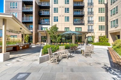 Outdoor patio area with seating and greenery