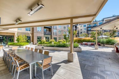 Outdoor dining area with tables and landscaping