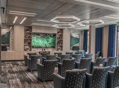 Interior common area with seating and a large screen
