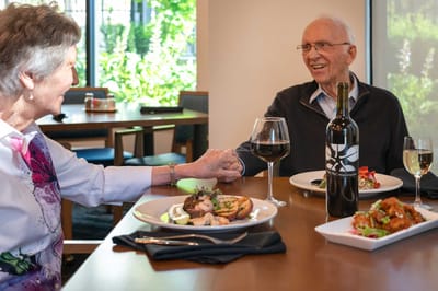 Residents enjoying a meal together in a dining room