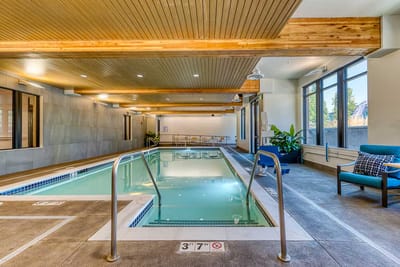 Indoor swimming pool area with seating