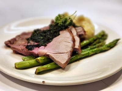 Close-up of a gourmet meal featuring roast meat and vegetables
