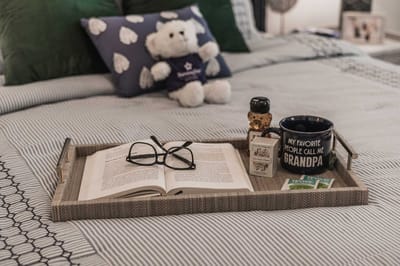 Cozy bedroom setup with a book and teddy bear