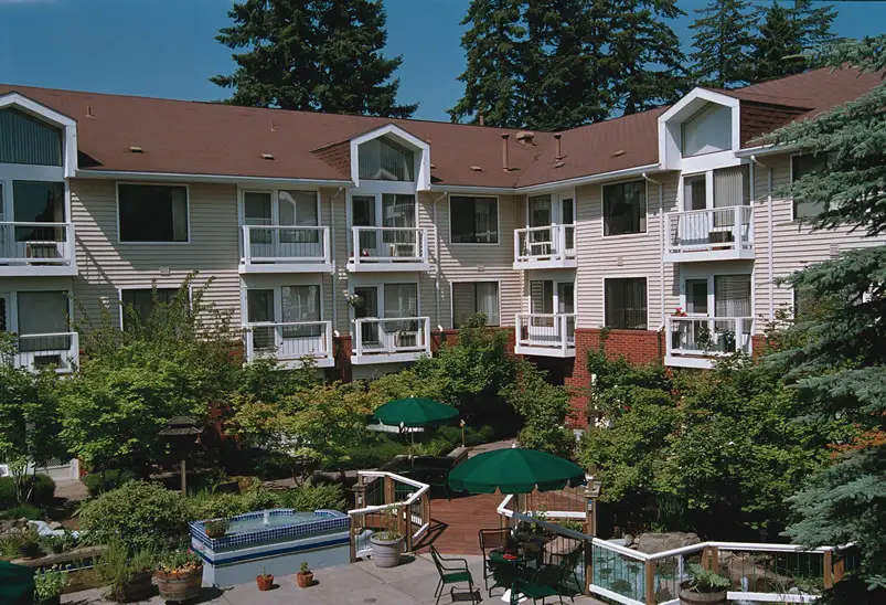 Exterior view of residential building with gardens and patios