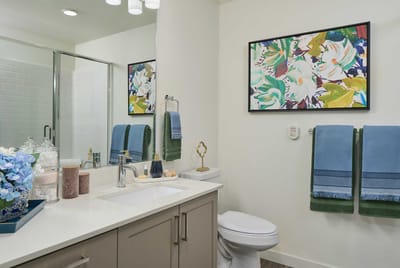 Brightly designed bathroom with floral artwork