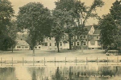 Exterior view of a senior living facility by a lake