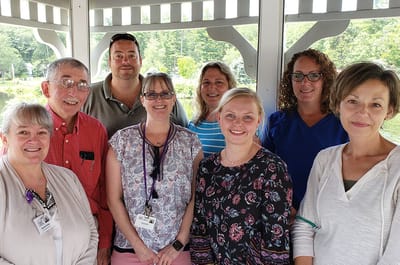 Staff members posing together outdoors