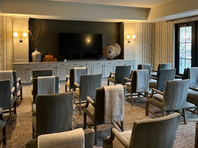 Interior common area with chairs and television.