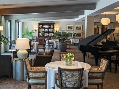 Elegant dining room with piano and fresh flowers