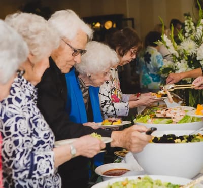 Residents enjoying a buffet meal together in a dining area