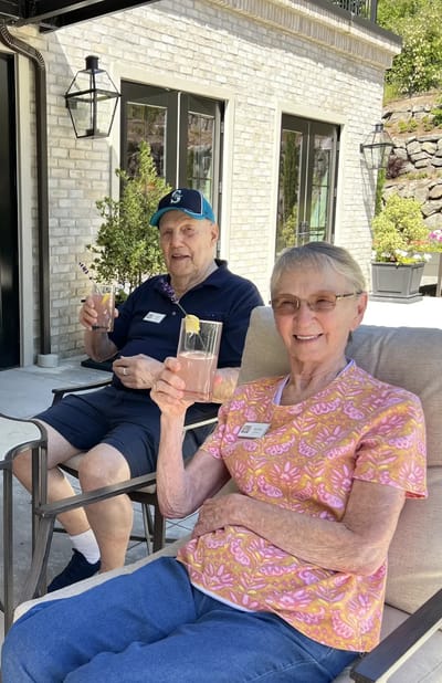 Two residents enjoying drinks in an outdoor space