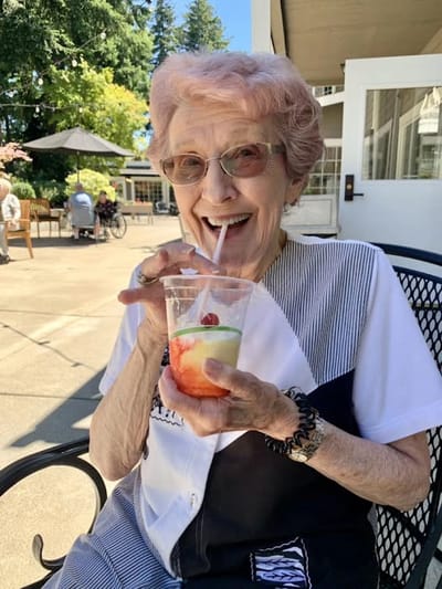 Resident enjoying a drink in an outdoor space