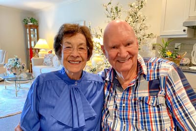 Two residents smiling in a cozy common area