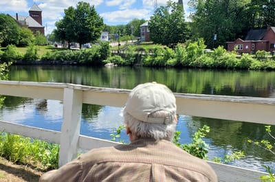 A resident enjoys the view by the water
